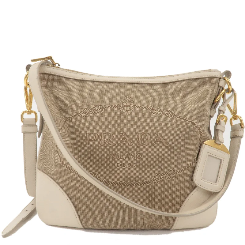 Prada bags with a snap - button closure and a decorative charm for a fashionable lookPrada bags with a snap - button closure and a decorative charm for a fashionable lookPRADA Logo Jacquard Canvas Leather Shoulder Bag Beige Ivory