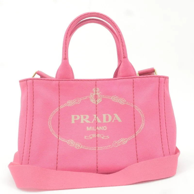 Prada tote bags with a printed Prada logo on the front for brand visibilityPrada tote bags with a printed Prada logo on the front for brand visibilityPRADA Logo Canapa Mini Canvas 2Way Tote Bag Pink 1BG439